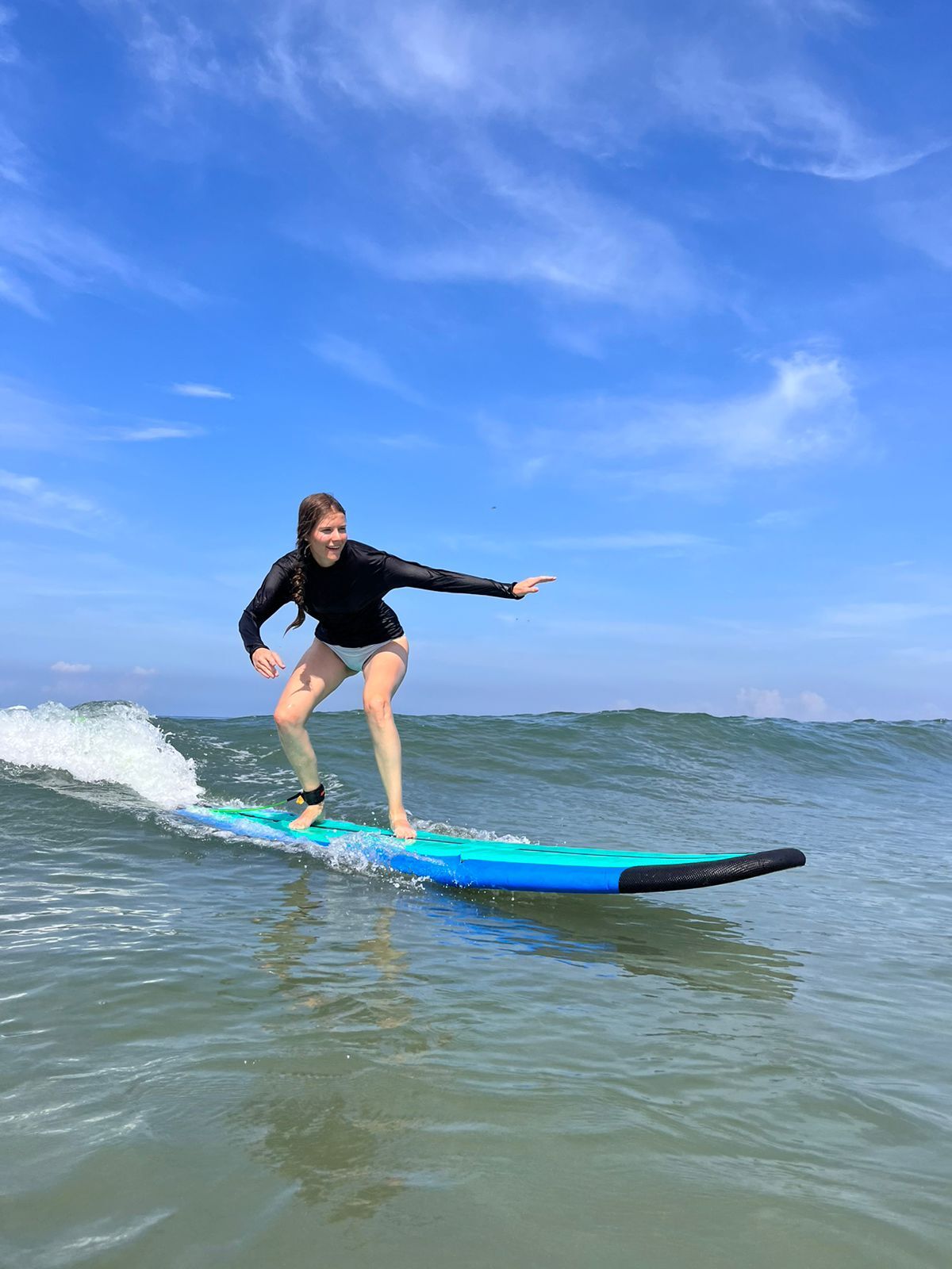 Surfer riding a perfect wave at sunset in Kuta Beach