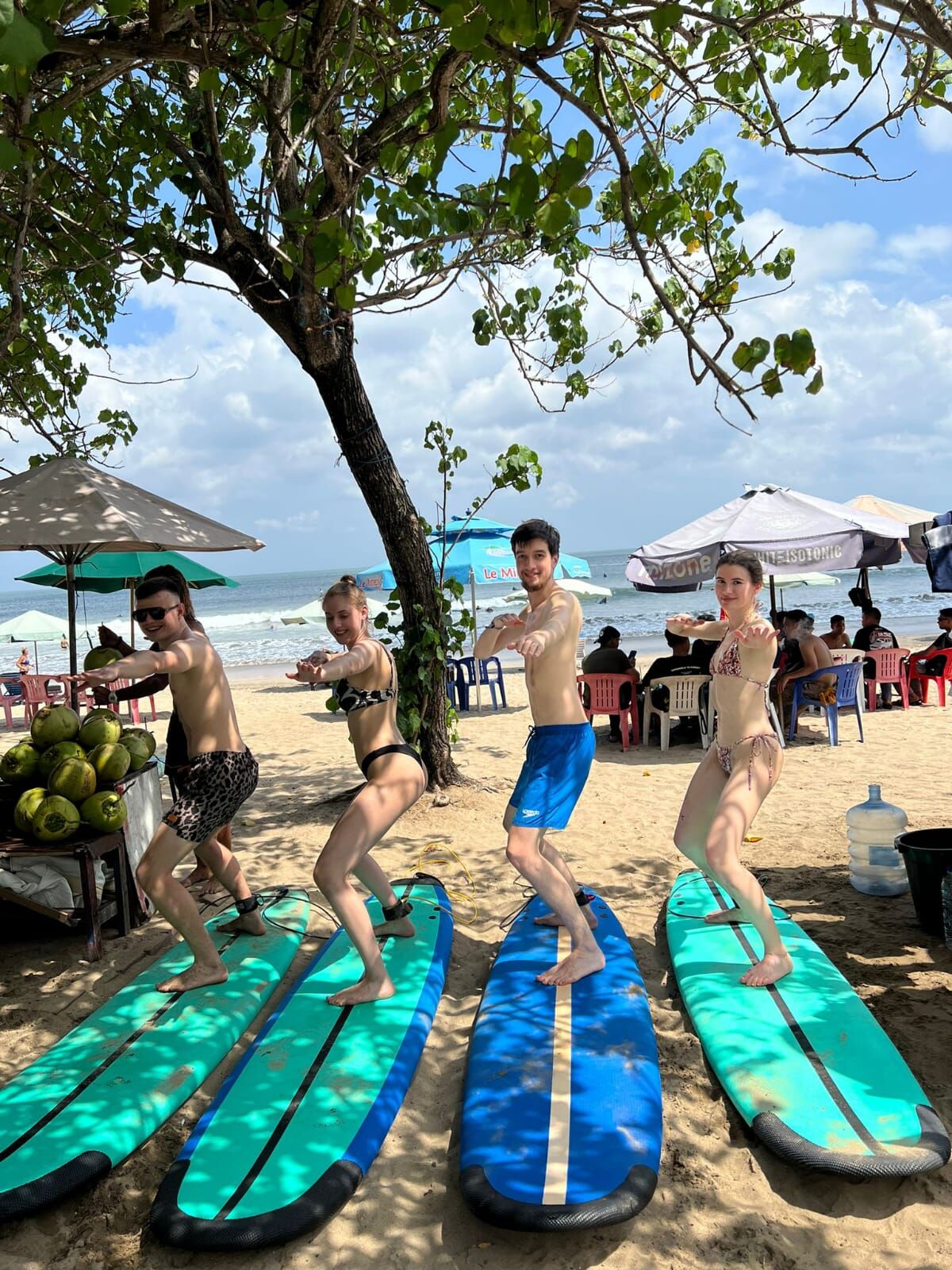 Group of friends celebrating after successful surf lesson