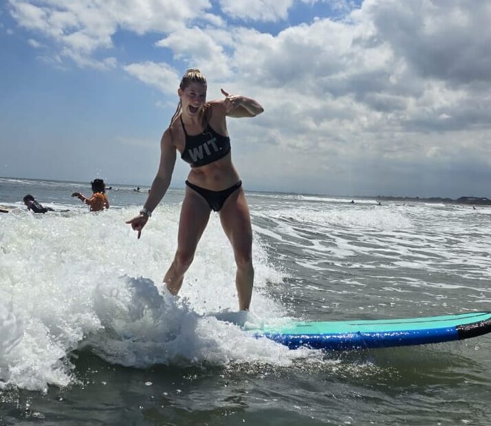 Beginner surfer learning to catch their first wave at Kuta Beach