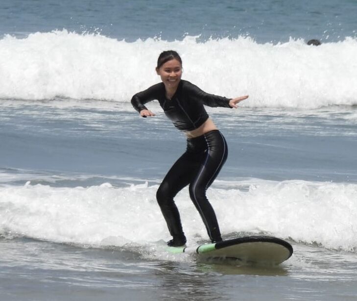 Professional surf instructor demonstrating proper surfing technique