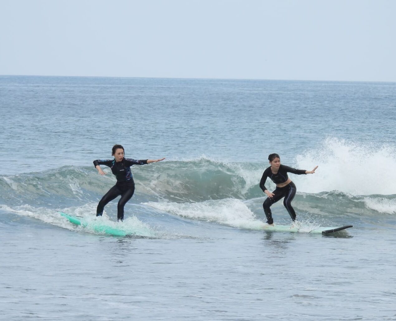 Happy students celebrating after successful surf session