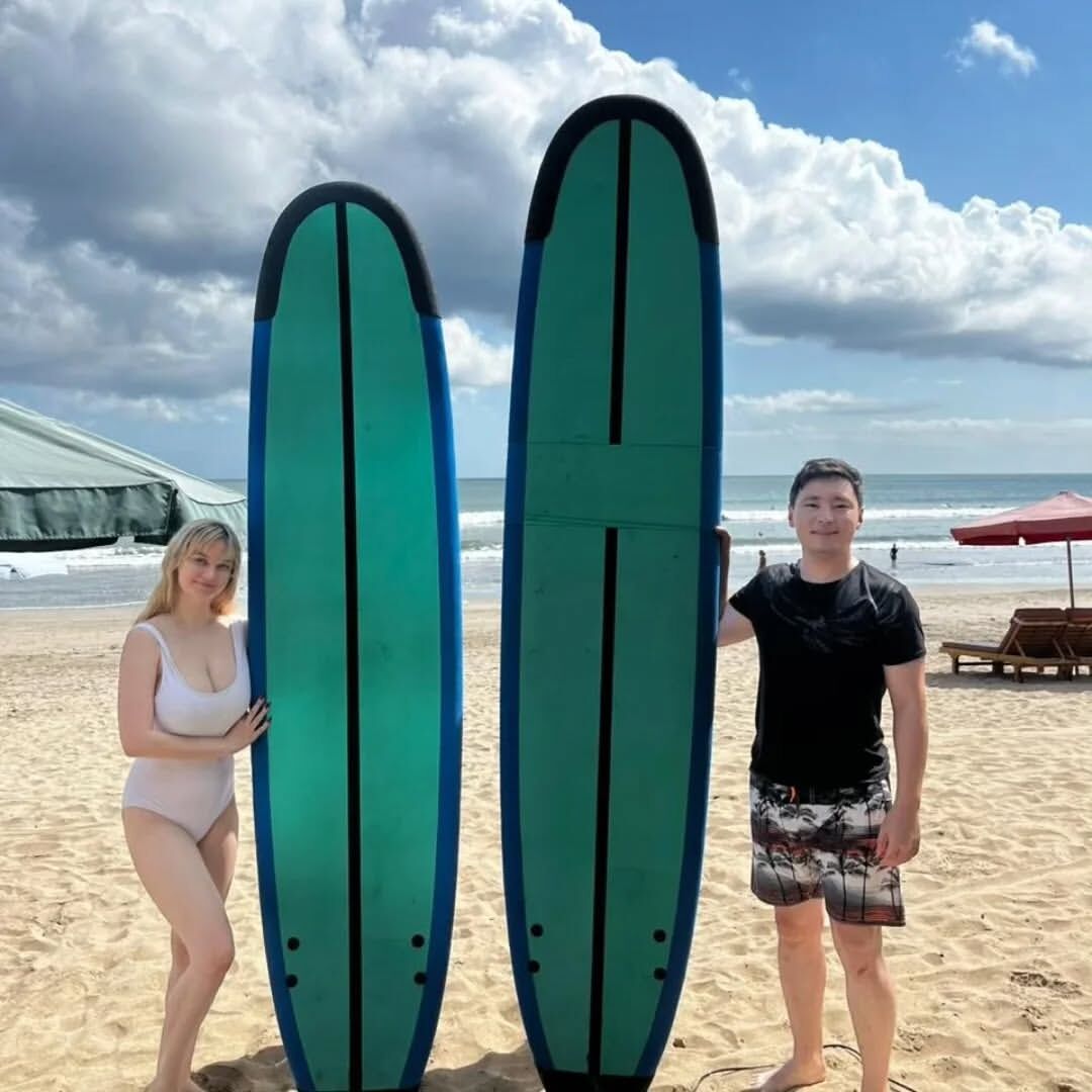 Group surf lesson with students practicing on the beach