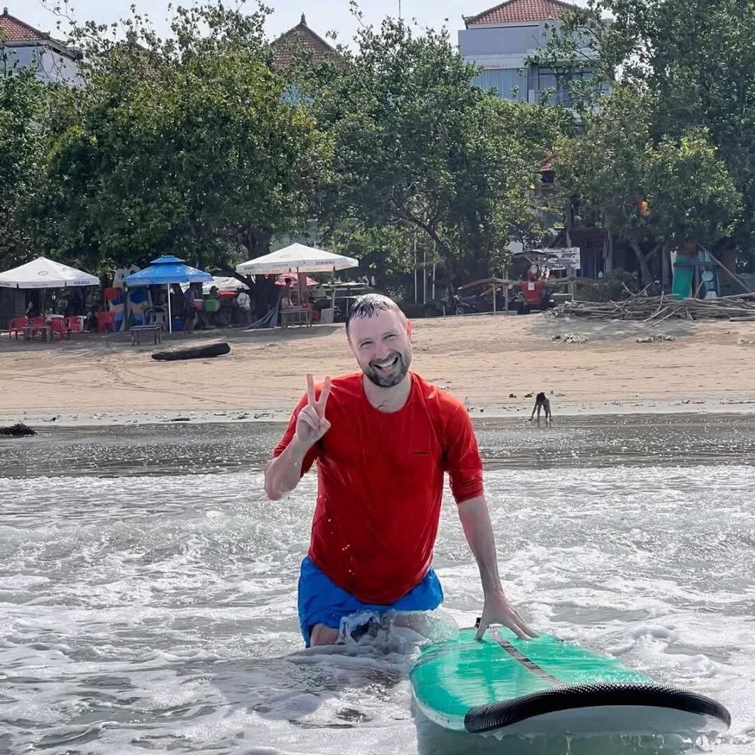 Instructor demonstrating surfing techniques to beginners